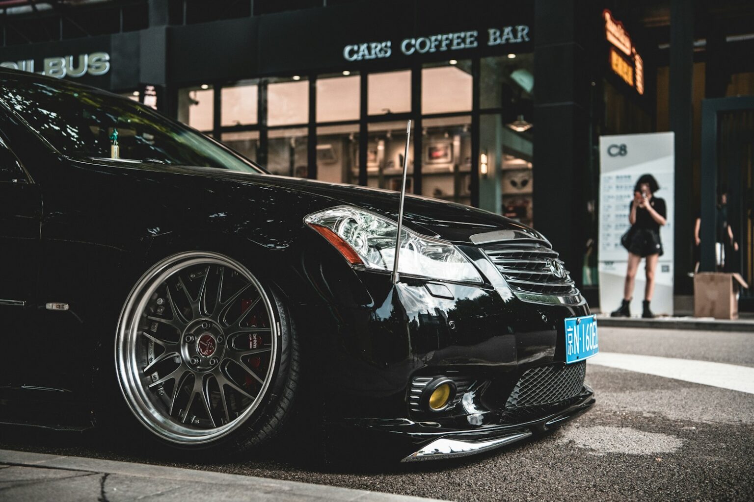 a black car parked outside a building